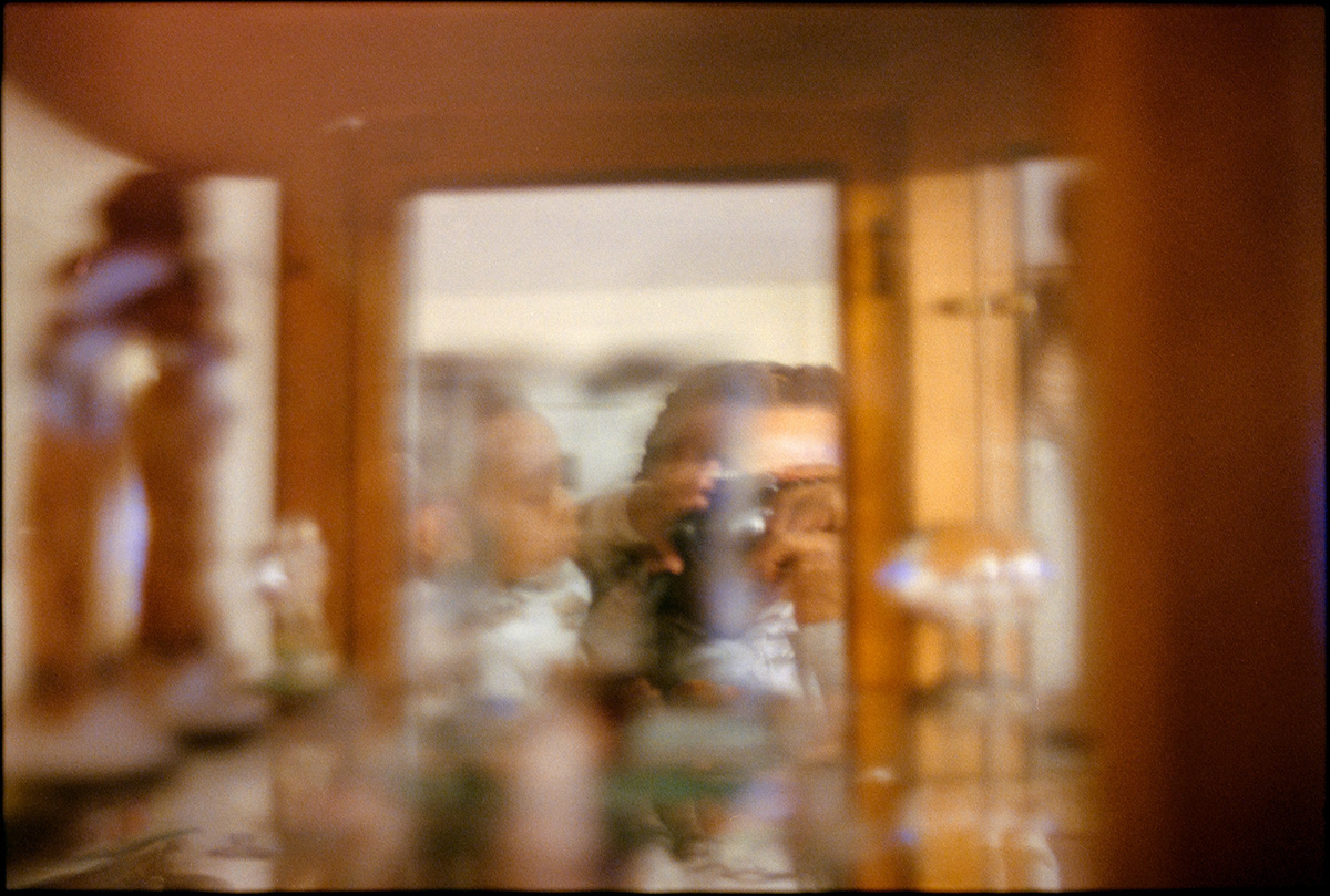 Blurred reflection through a mirror with a child reaching toward the camera