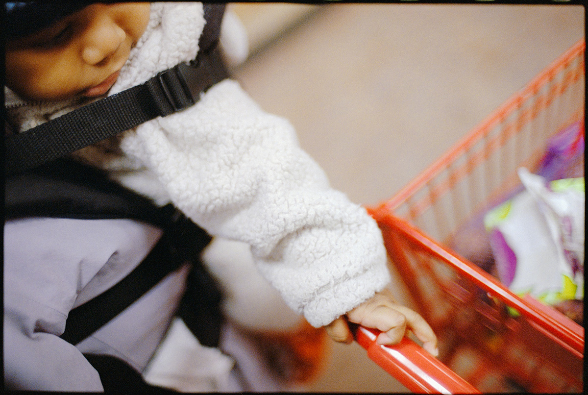 Hand near a shopping cart in a quiet everyday moment