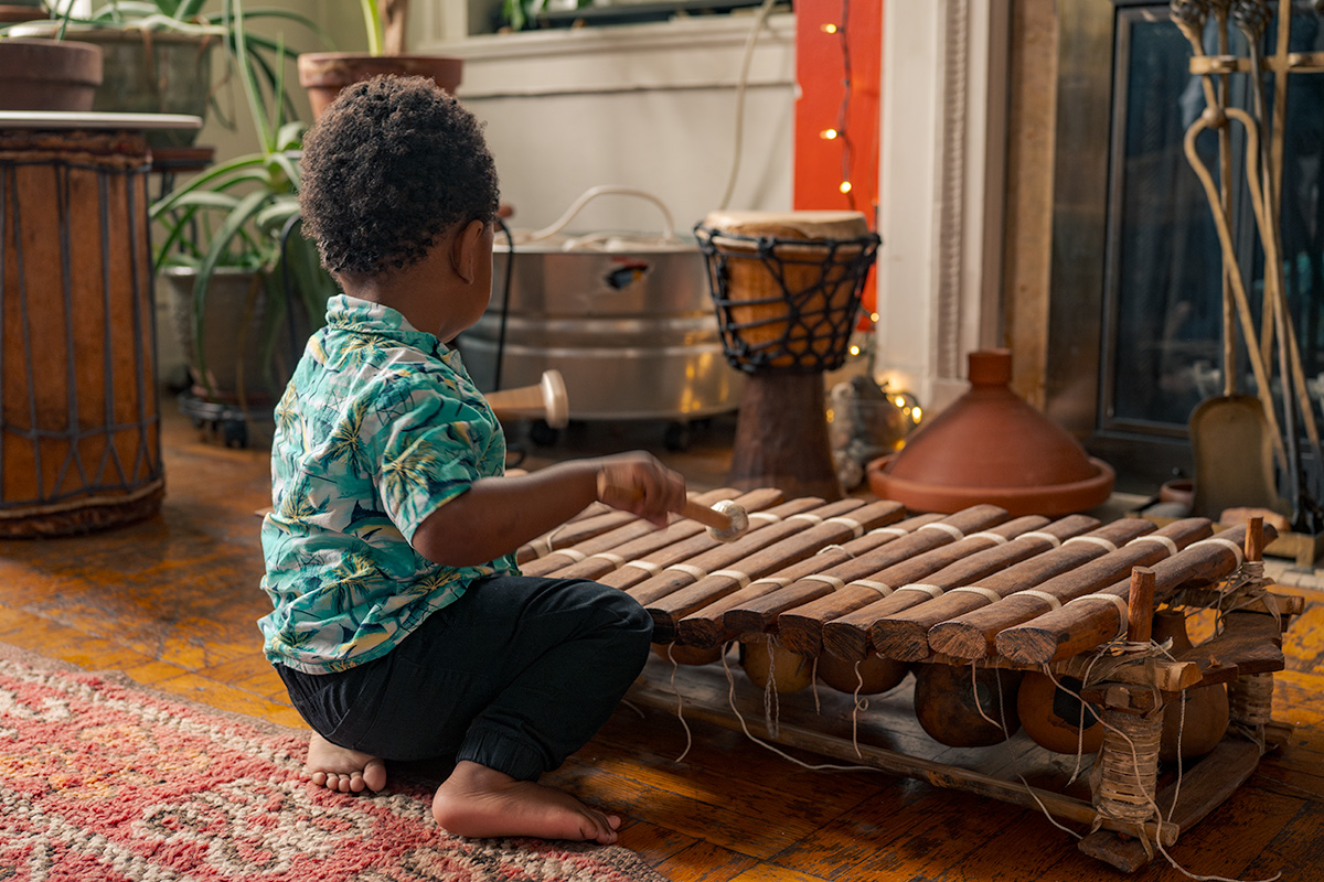 Child playing with a musical instrument