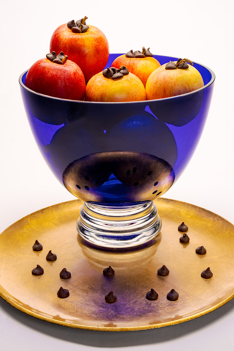 Still life photograph of fruit in a blue bowl